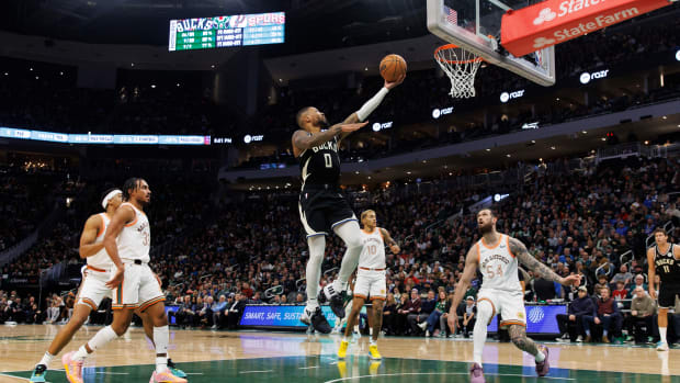 Dec 19, 2023; Milwaukee, Wisconsin, USA; Milwaukee Bucks guard Damian Lillard (0) drives for a layup during the second quarter against the San Antonio Spurs at Fiserv Forum.
